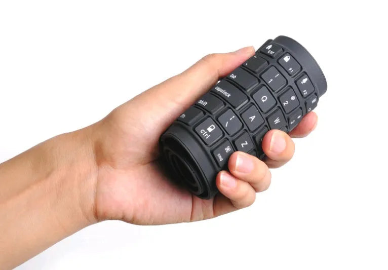 Black Bluetooth folding silicone keyboard with 108 keys and IP67 waterproof rating placed on a desk