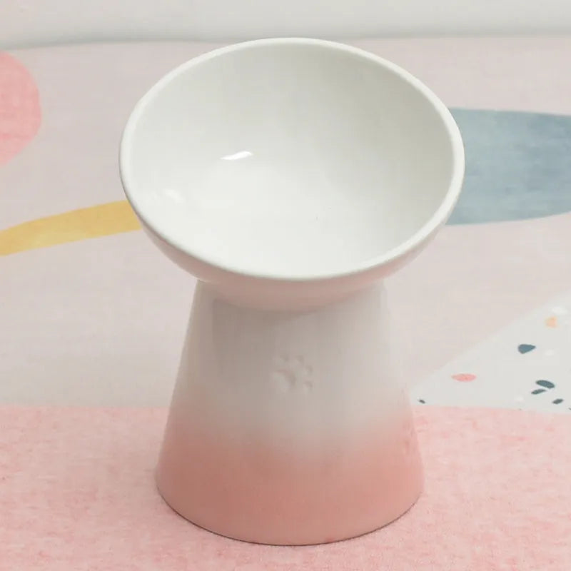 White ceramic pet bowl with a high foot base and wide, shallow eating area for dogs and cats