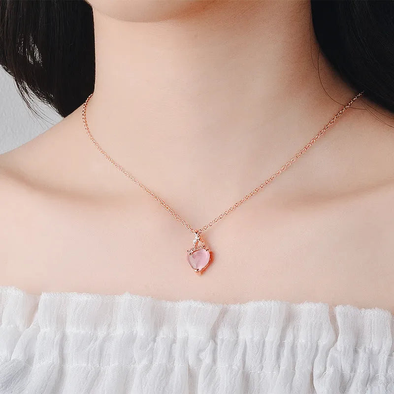 Heart-shaped pink crystal pendant necklace with rose gold cross chain for women