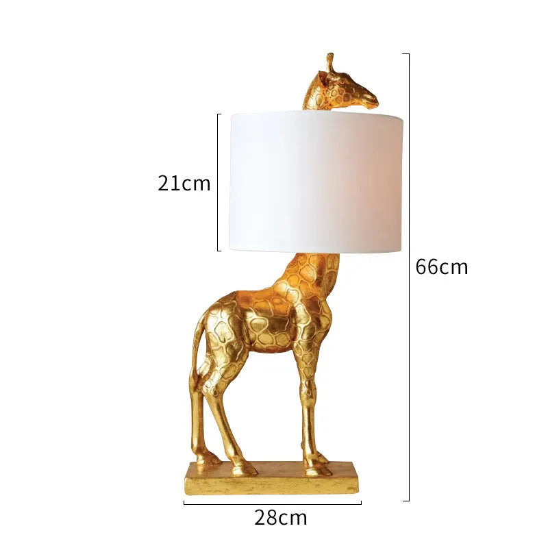 White giraffe table lamp with cloth shade on wooden bedside table