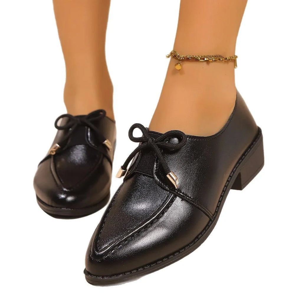 Women's pointed toe shoes with a choice of large buckle bow or small bowknot detail on a PU leather upper.