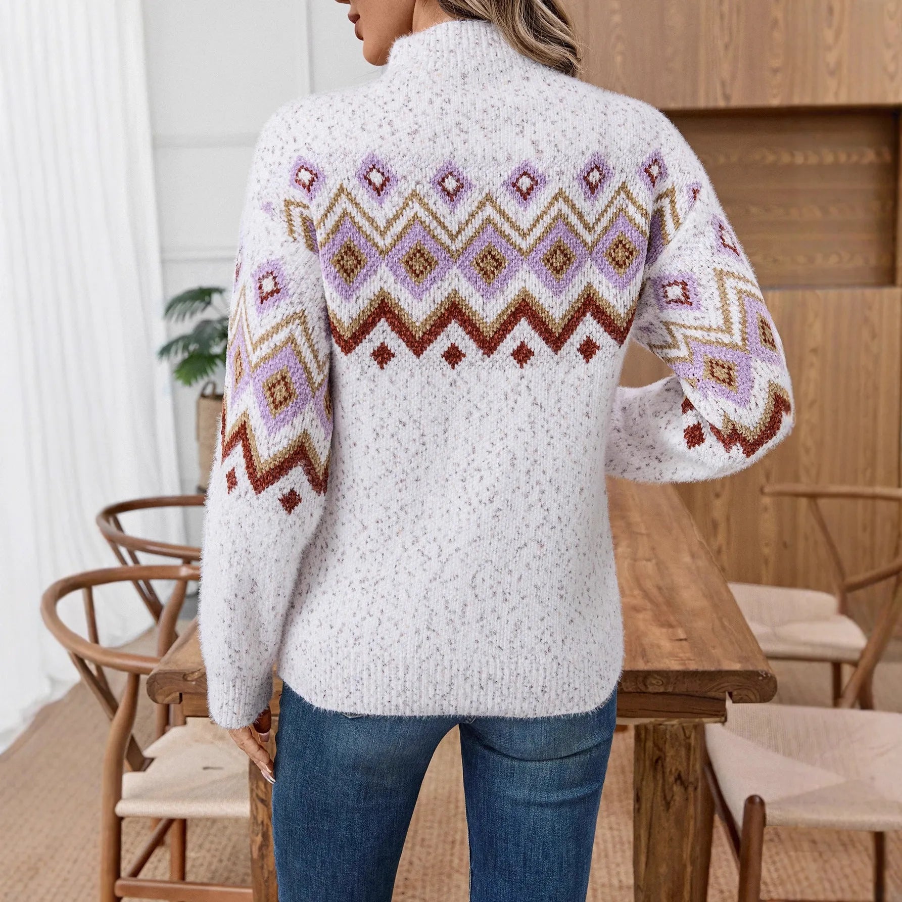 White loose-fit geometric pattern sweater with a half turtleneck neckline.