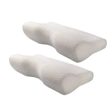 Butterfly-shaped blue memory foam cervical pillow on a bed.