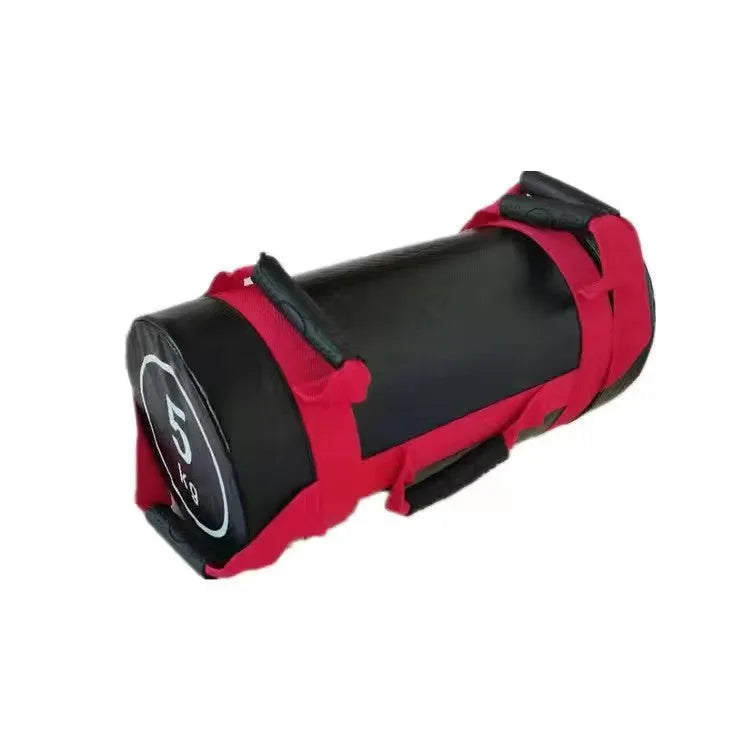 Flat white PVC fitness sandbag on gym floor, showing size and sturdy handles for weight training.