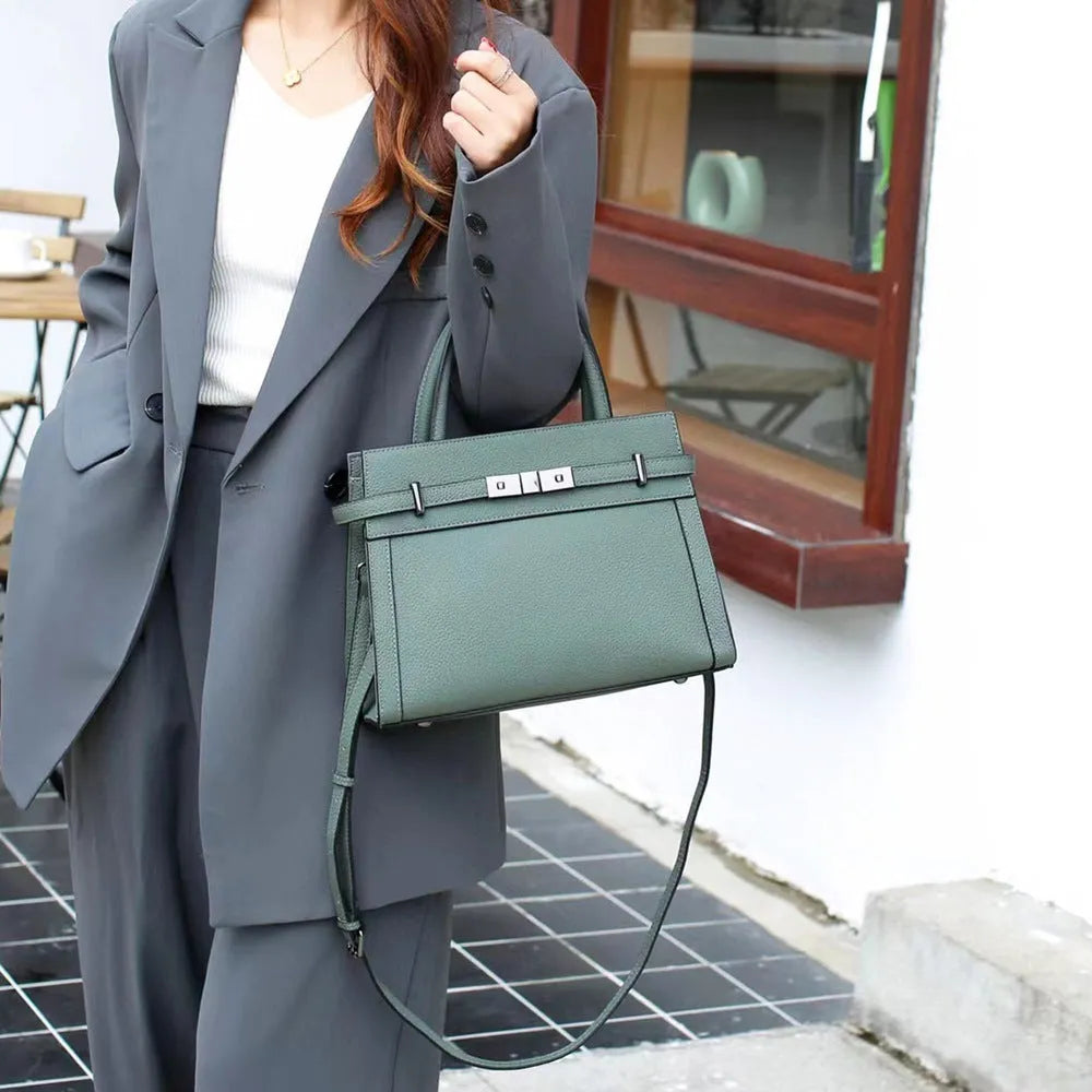 Small square horizontal genuine leather shoulder bag in almond green with visible stitching and shoulder strap