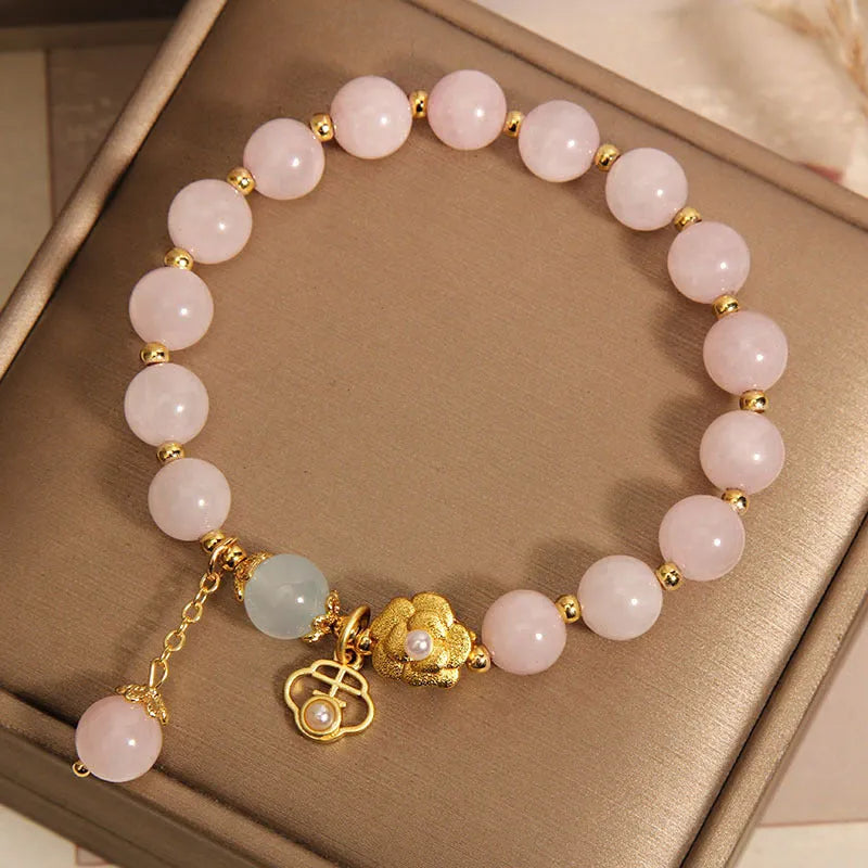 Women's pink crystal flower bracelet with detailed floral bead design on wrist