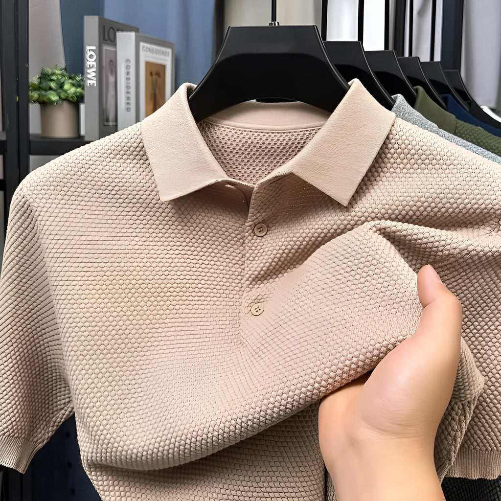 Man wearing a loose grey cotton short sleeve pullover sweater for casual leisure wear.