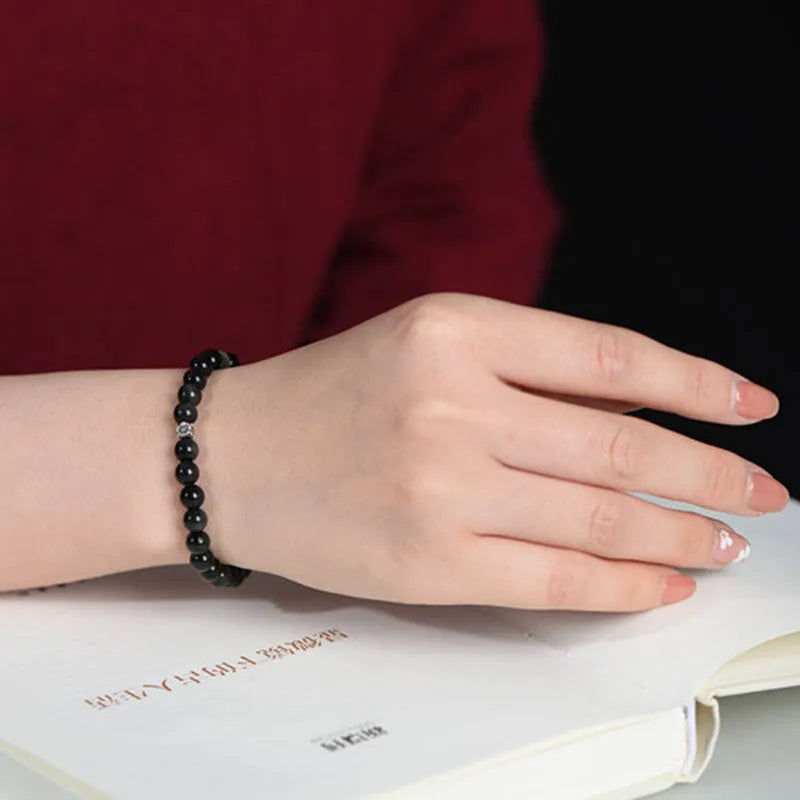 Natural obsidian bracelet with S925 silver flower accessories showing 6mm stone beads