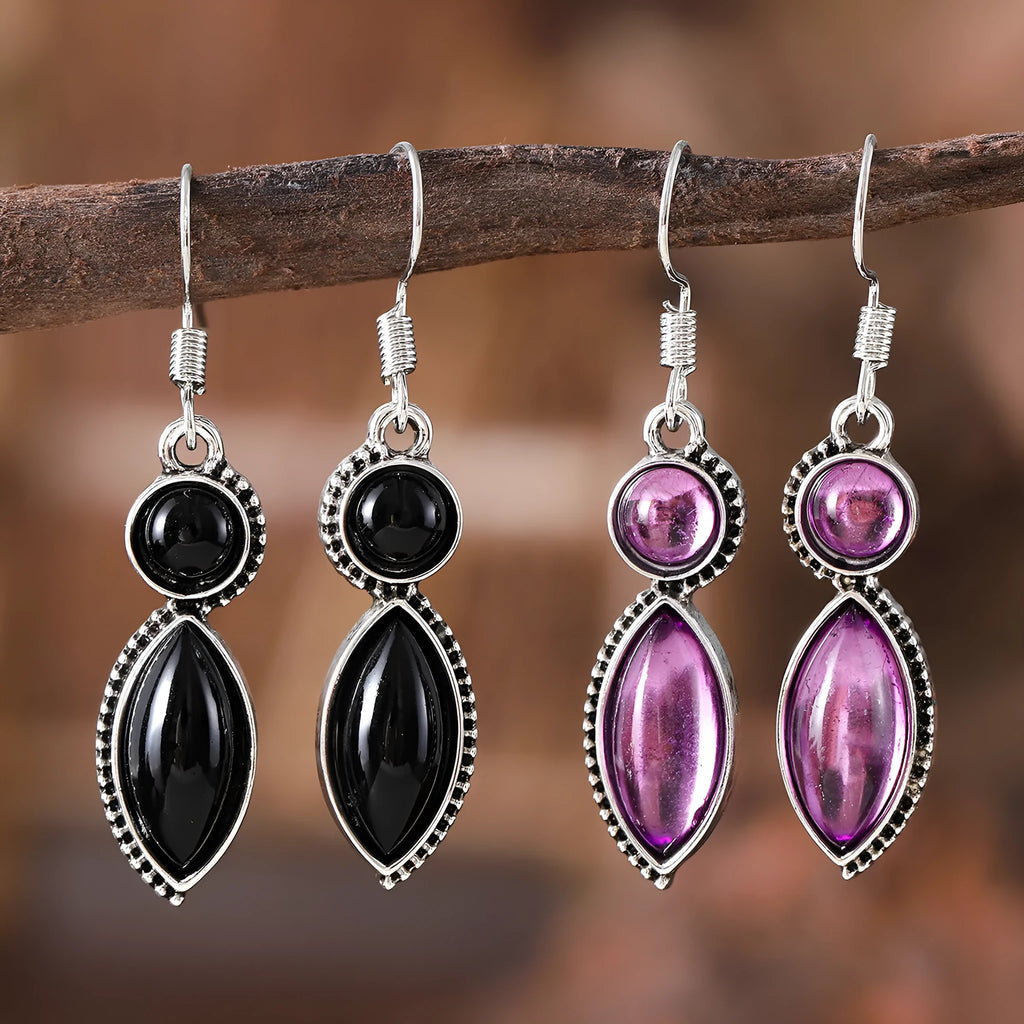 A pair of vintage-style geometric drop earrings with a round detail in black and purple electroplated zinc alloy.