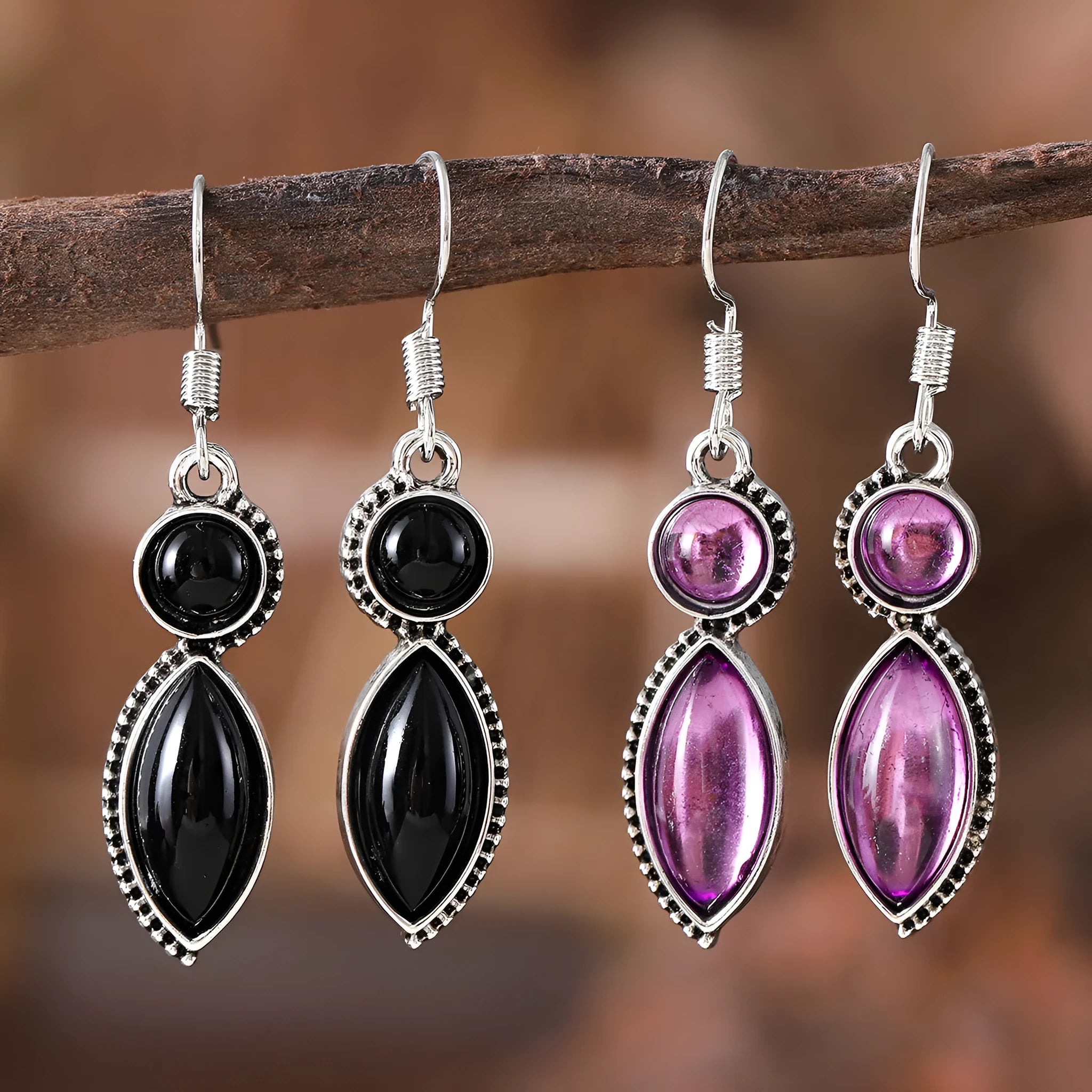 A pair of vintage-style geometric drop earrings with a round detail in black and purple electroplated zinc alloy.