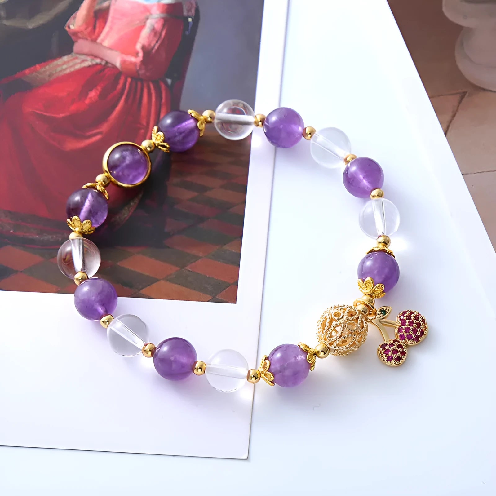 Close-up of a women's purple crystal bracelet with a micro-inlaid cherry flower design on an adjustable band.