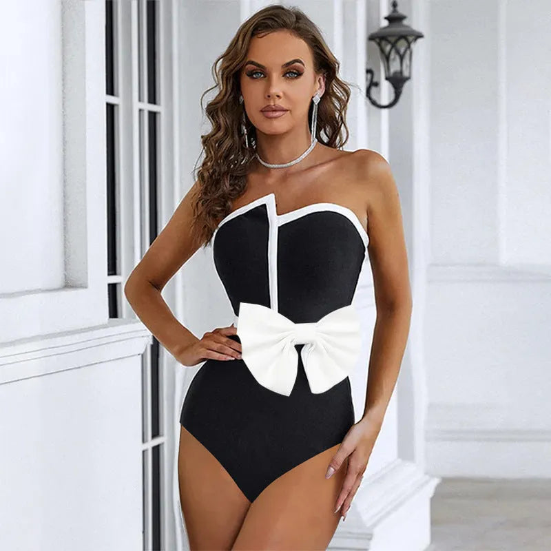 Black and white colour-block women's one-piece swimsuit with an asymmetrical bow on the tube top.