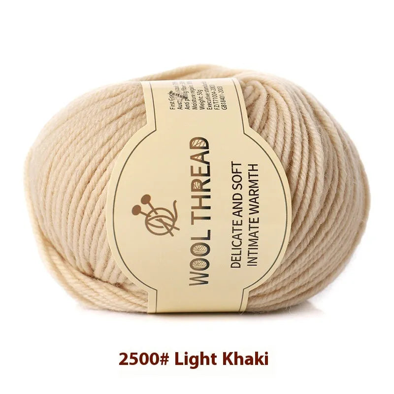One roll of beige domestic wool hand-knitting yarn for size 10 needles next to knitting needles.
