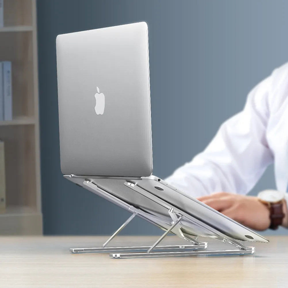 Silver foldable aluminium laptop stand holding a MacBook at an adjusted angle