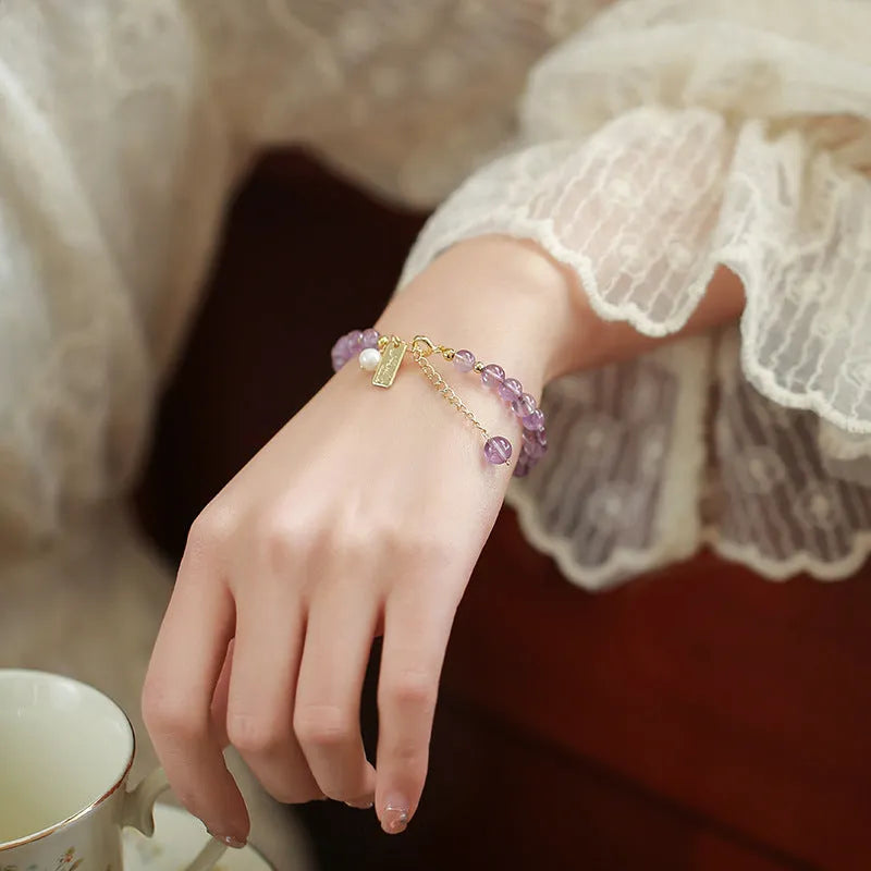 Women's natural crystal bracelet with lavender amethyst stones and animal zodiac design
