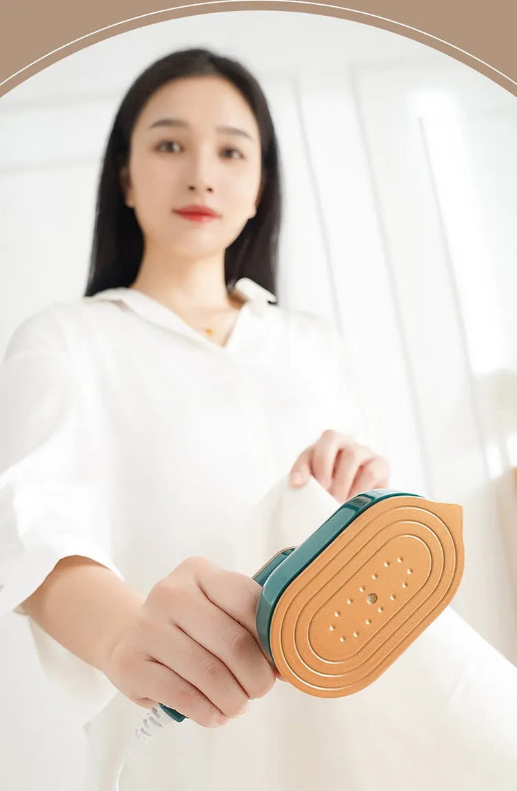 Mini garment steamer in white with steam and dry iron function for household and travel use