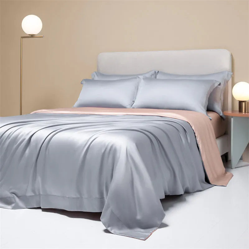 Aurora Blue 200 thread count Tencel duvet cover, fitted sheet, and pillowcases laid on a modern bed.