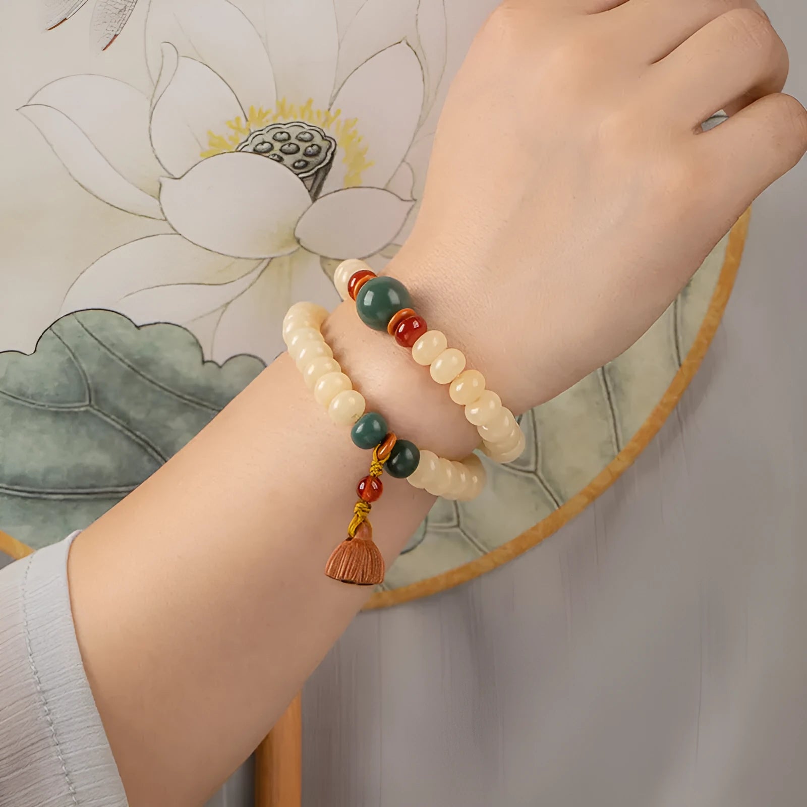 Cream topaz bodhi root wooden bracelet with flat round beads on wrist