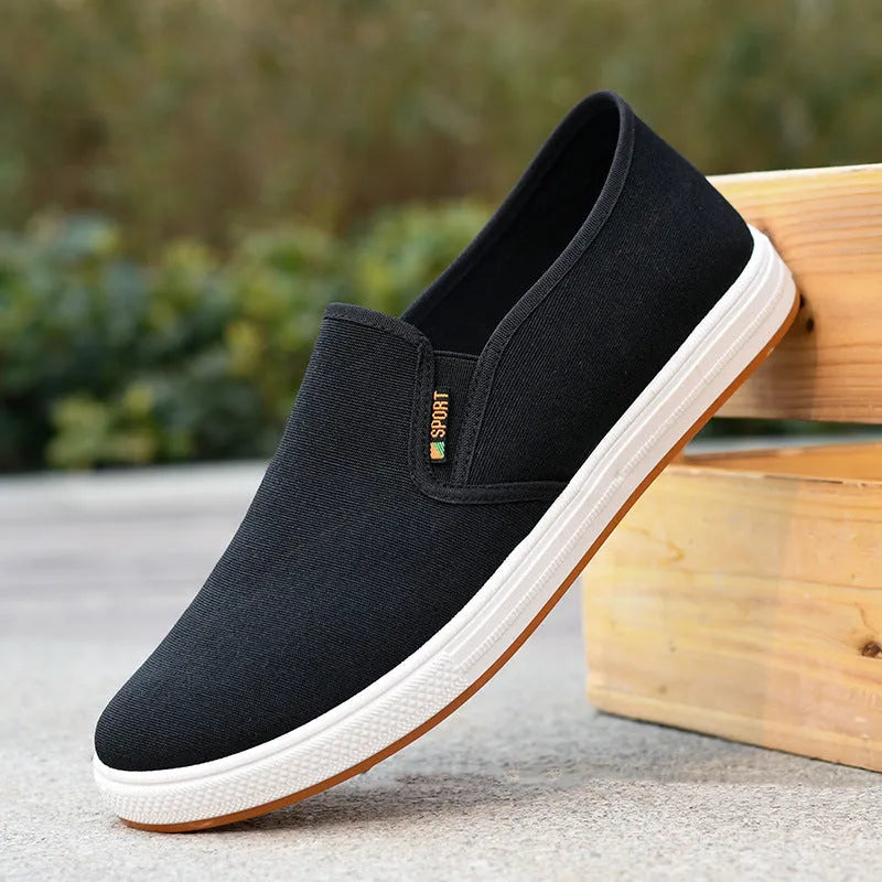 Men's low-top canvas trainers with slip-on design and round toe shape in black colour