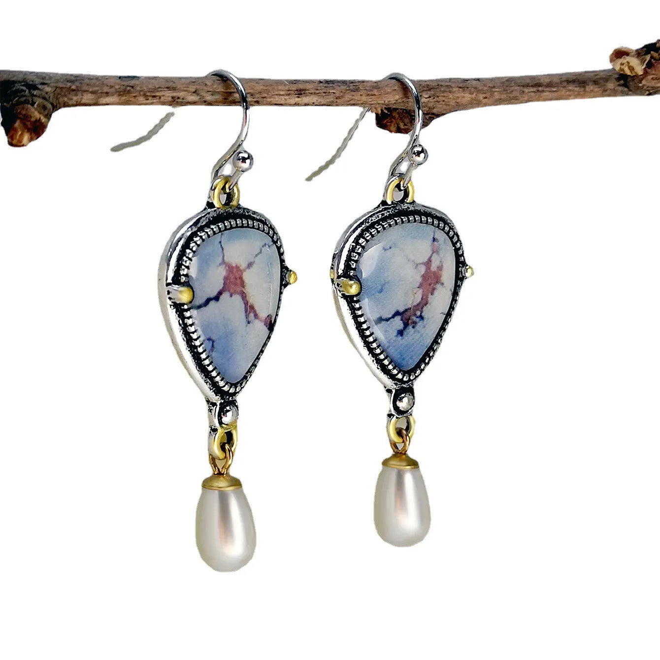 Retro blue drop earrings with synthetic blue opal and white pearl on a geometric metal setting.