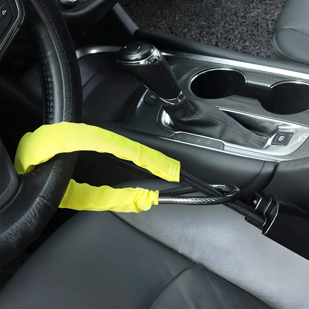 Red iron wire rope steering wheel lock for General Motors cars on a steering wheel.