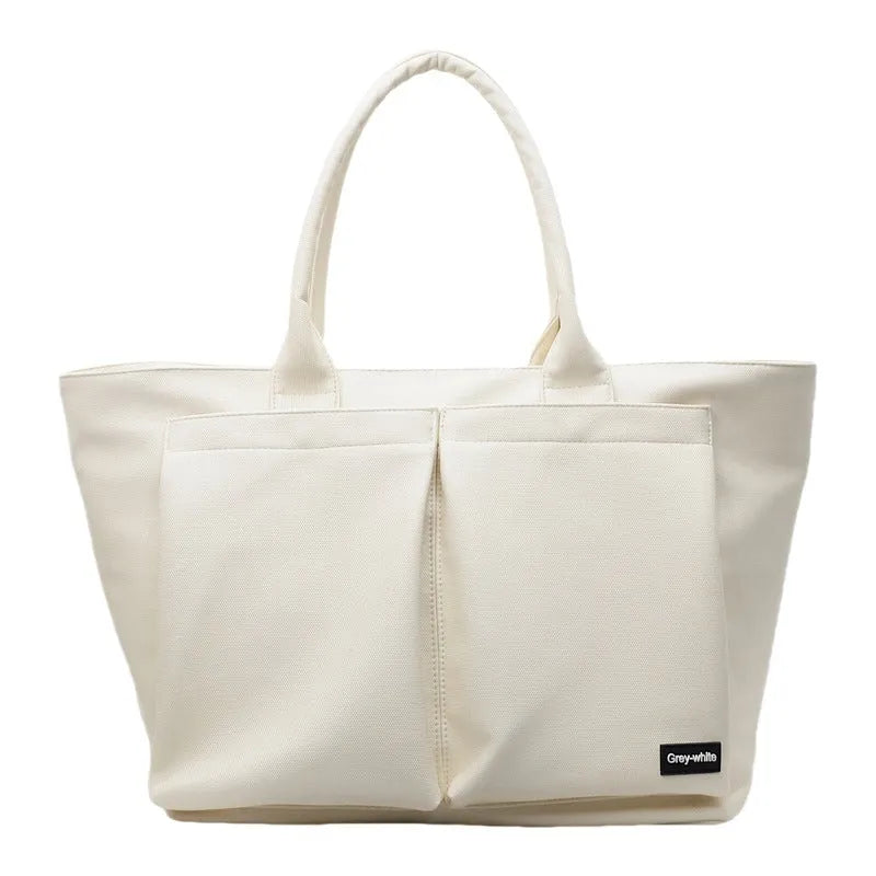 Lightweight expandable PU shoulder bag shown in solid green colour with ventilation panel