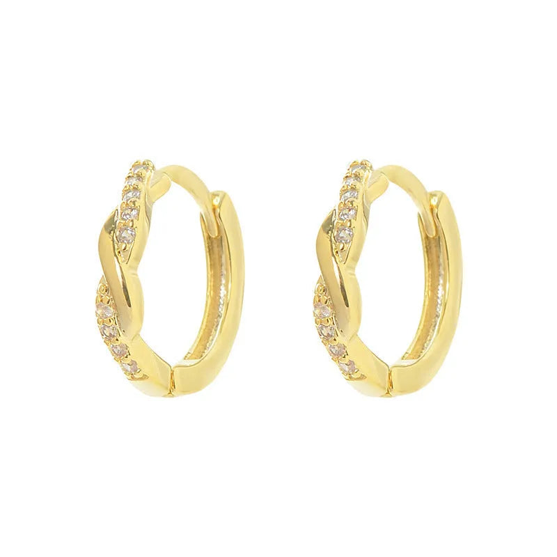 Close-up of women's geometric ear clips with interwoven hemp rope centre in gold tone.