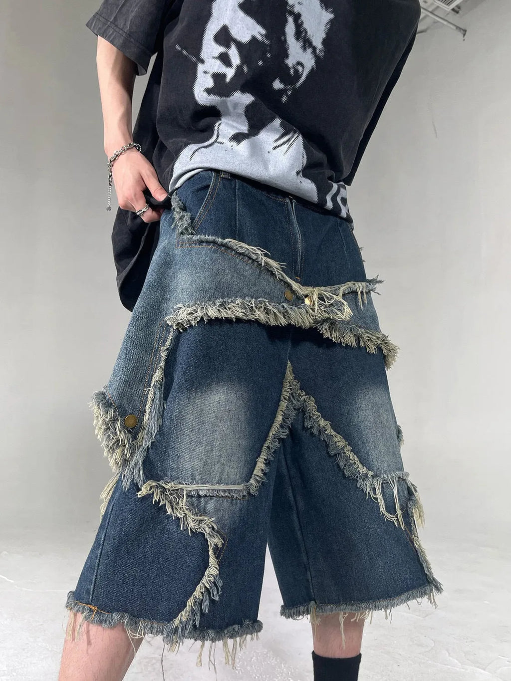 Blue denim shorts with frayed five-pointed star design detail, loose fit cut for summer casual wear