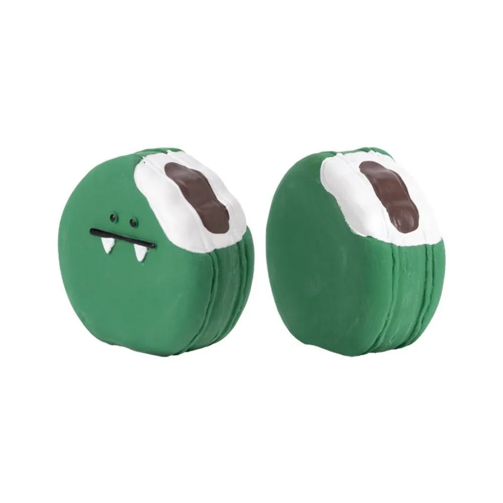 Green and yellow latex dog chew toy shaped like cartoon egg bread with a squeaker.