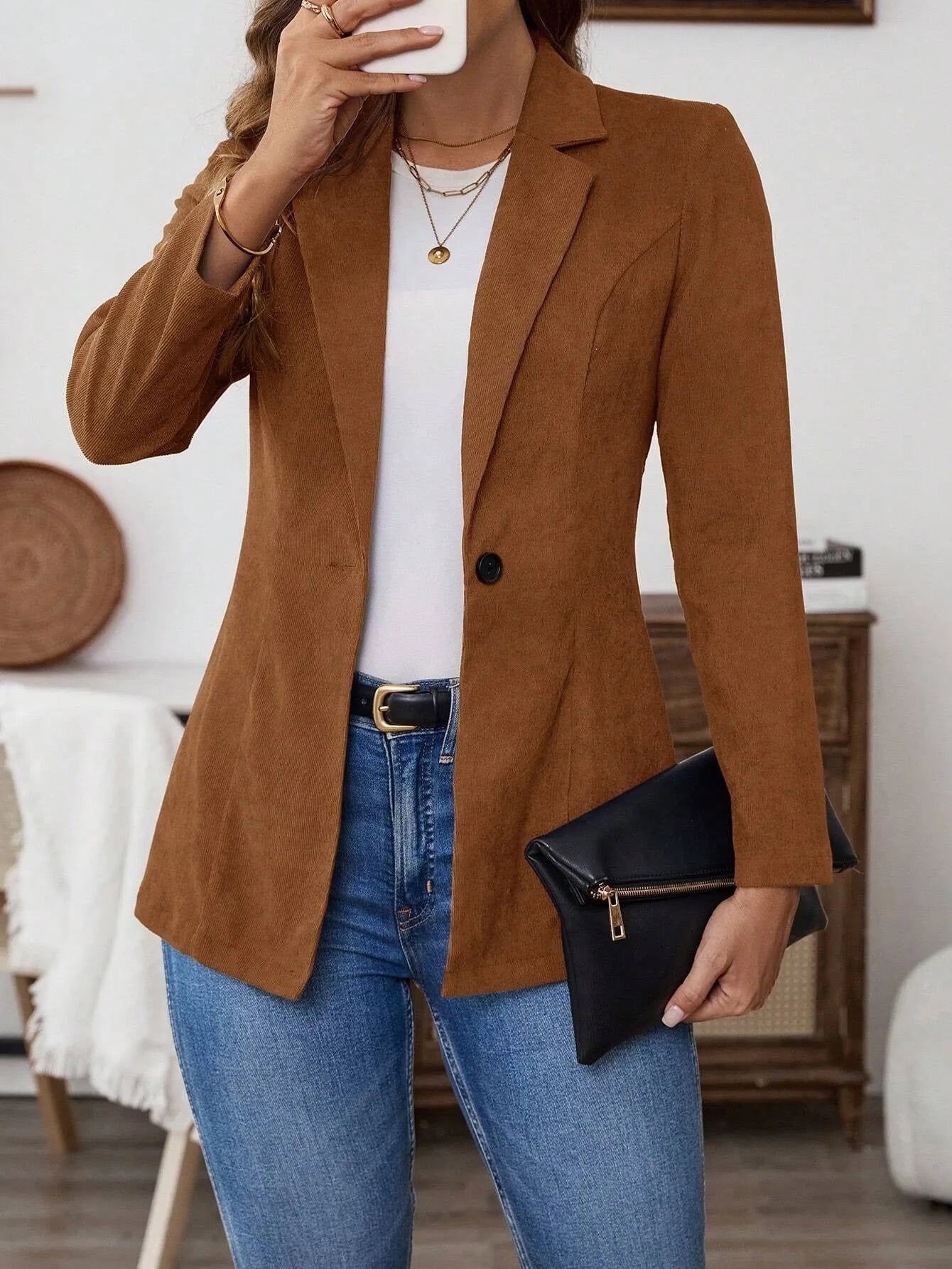 Brown single-breasted lapel blazer for men on a hanger.