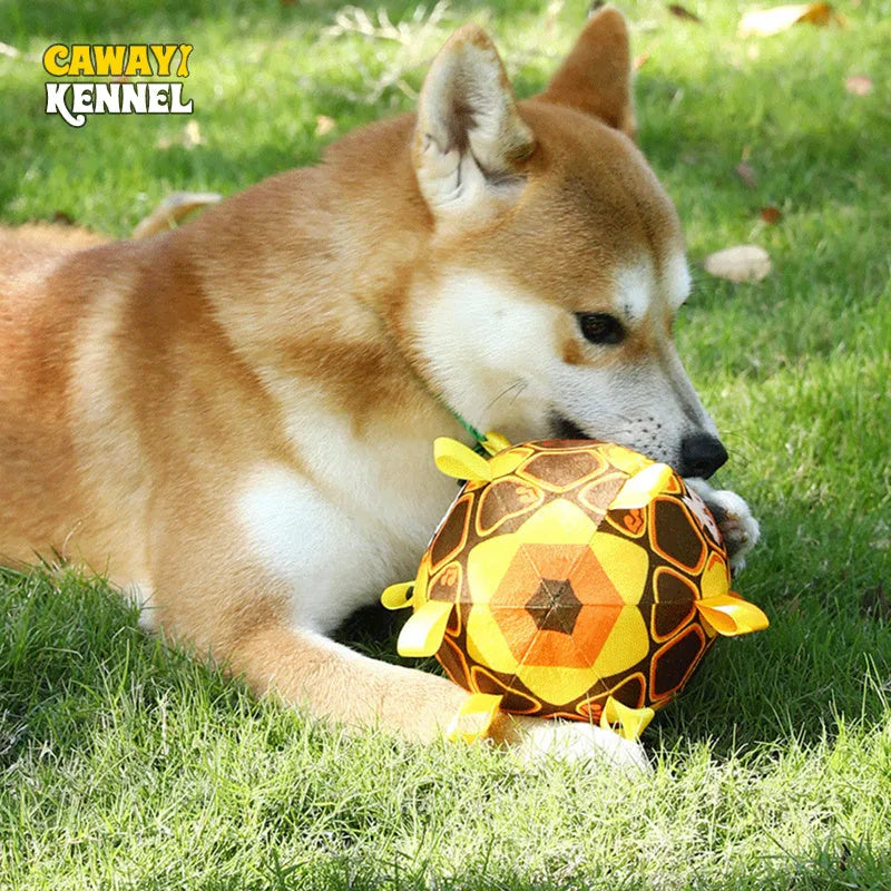 Green plush ball dog toy with a handle and internal bells, 15cm in diameter.
