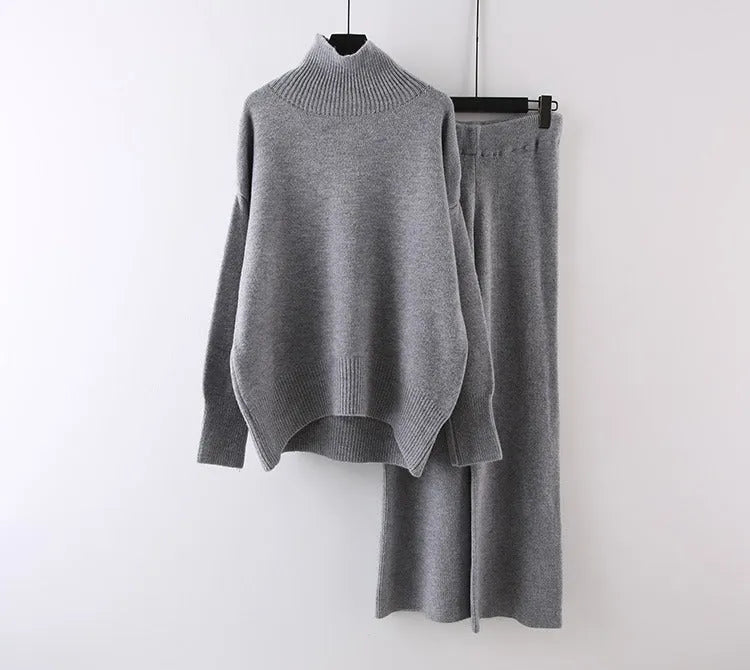 Women's milky white acrylic knit sweater and wide-leg trouser two-piece set on a hanger.