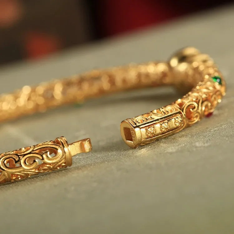 Gold-toned open design gourd charm bracelet with a dark adjustable silk cord for women.