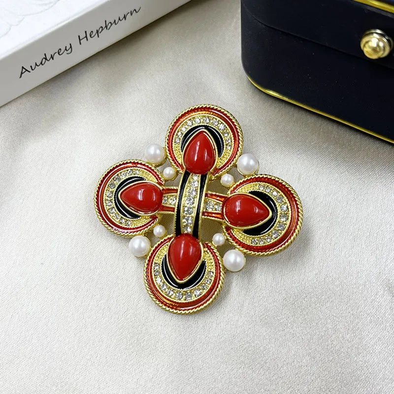 Close-up of vintage medieval baroque cross brooch with crystal accents on zinc alloy.