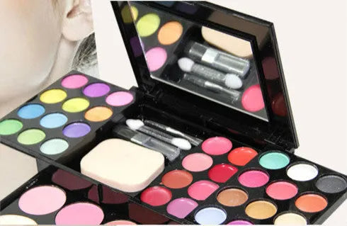 Three-layer makeup box set open showing 24 colour eyeshadow, 8 colour lipstick, 4 colour blush, powder cakes and mirror