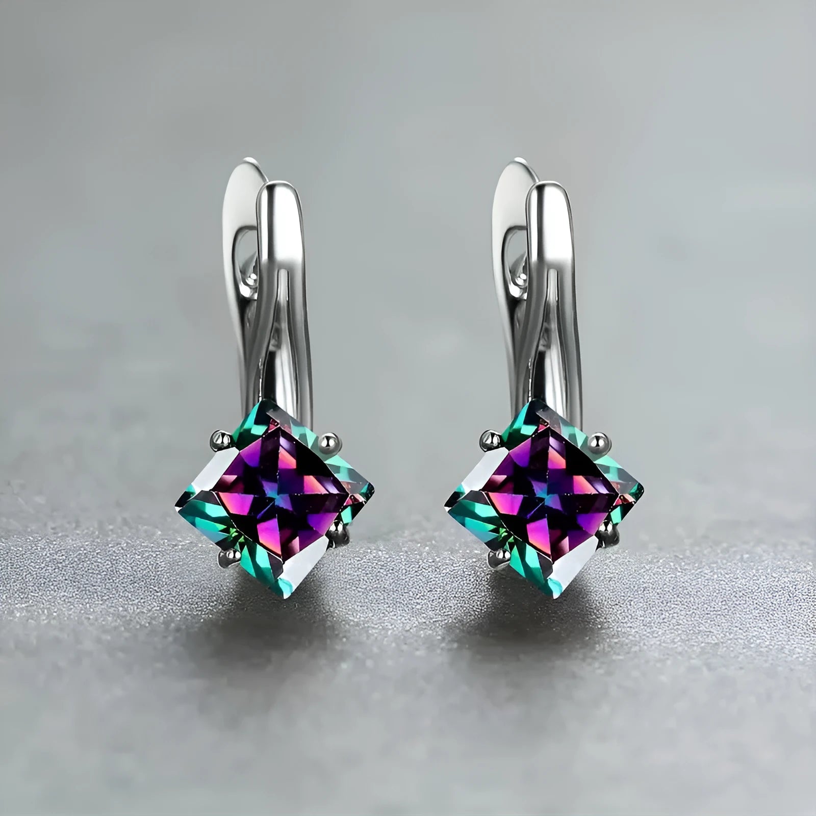 A pair of simple copper earrings with a diamond design created from inlaid zircon stones.