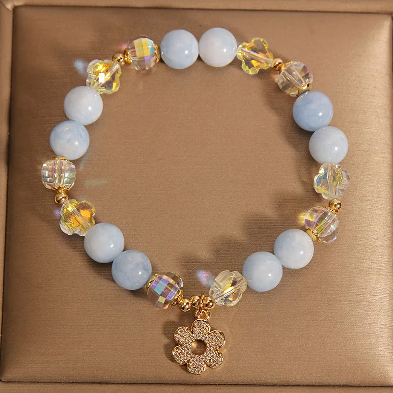 Women's aquamarine crystal bracelet with four-leaf clover charm and pearl decorative accents