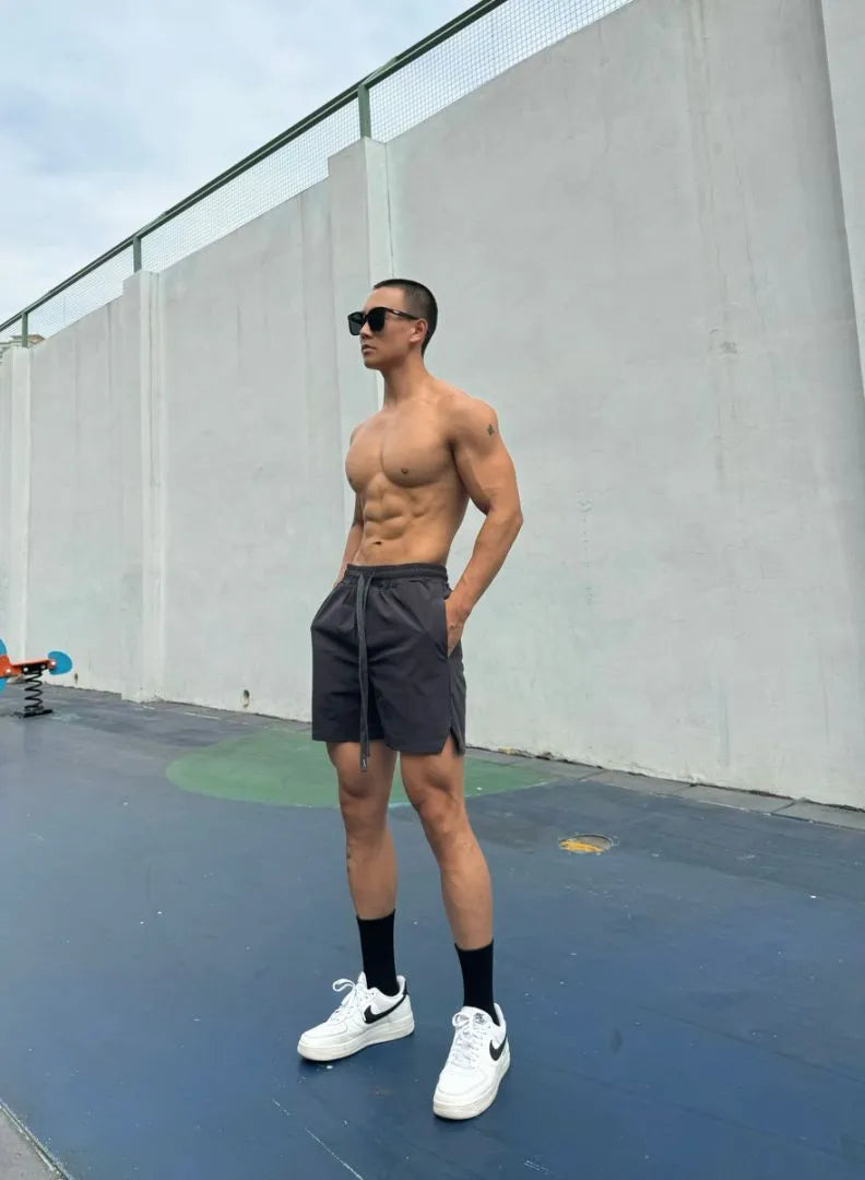 Men's ice silk quick-drying double-layer casual shorts in black, shown on a model.