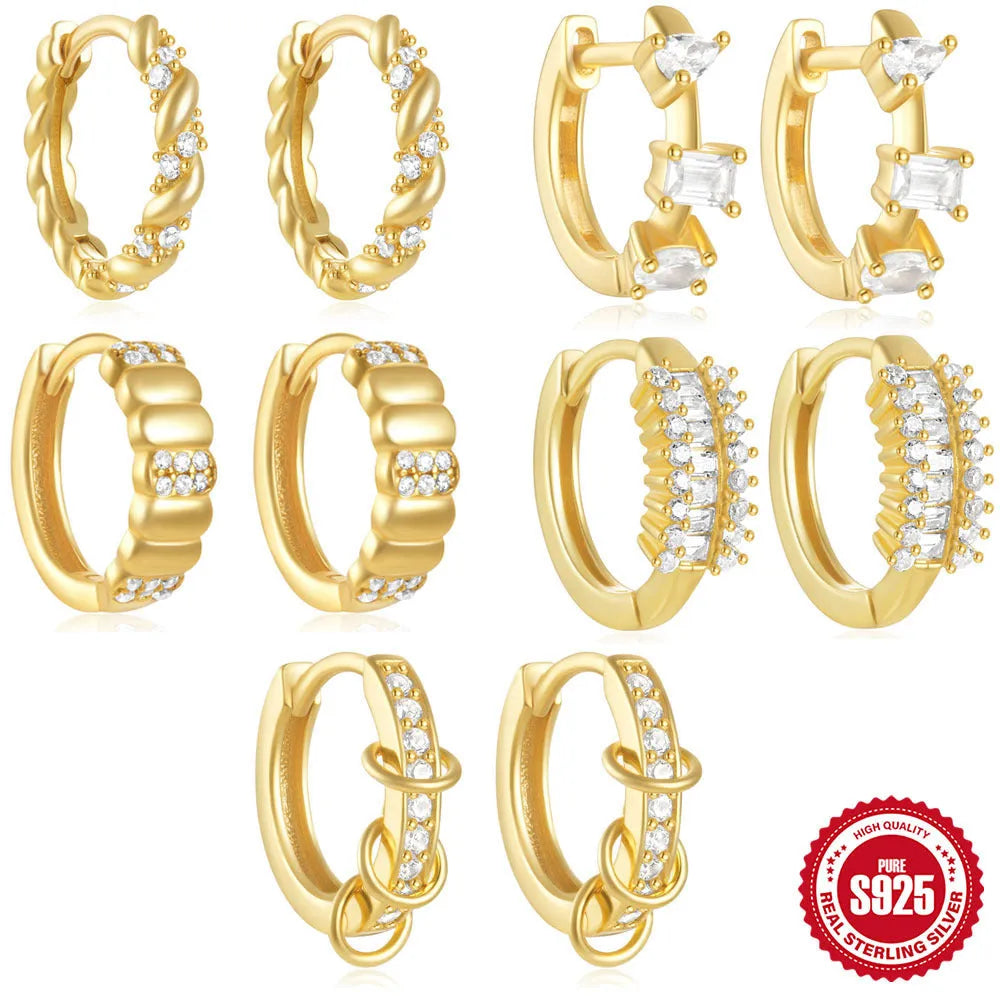 A pair of small round geometric stud earrings in sterling silver with a gold electroplated finish.