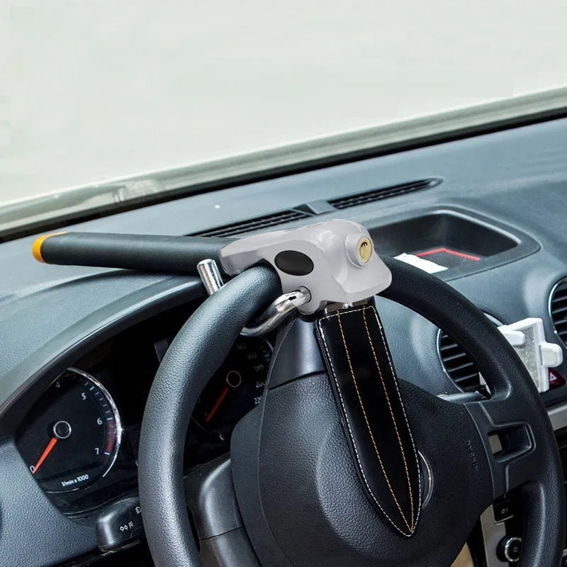 Universal car steering wheel lock in black gold, steel and aluminium alloy with copper core alarm, includes keys and wrench