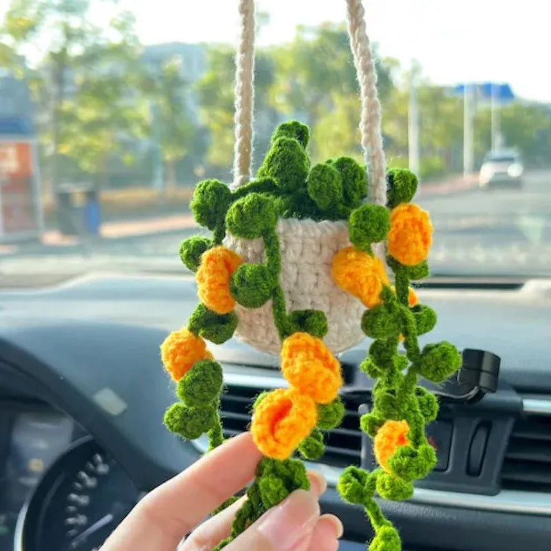 Green and white knitted wool car plant decoration with basin base and hanging rope