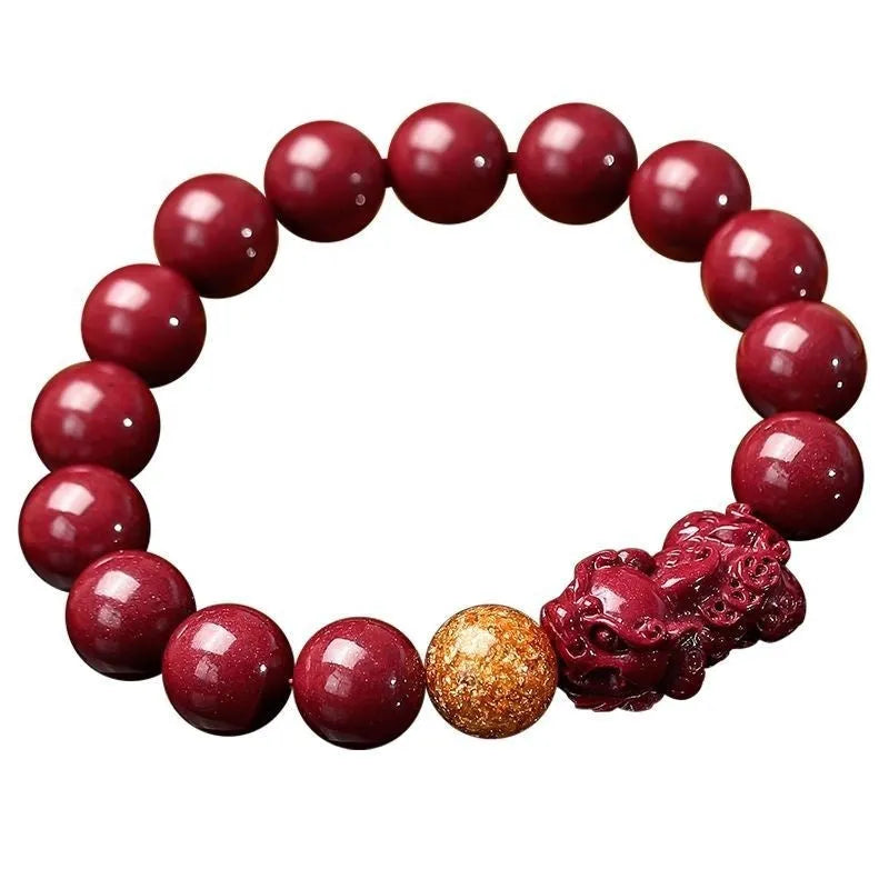 Polished purple and gold sandstone cinnabar bracelet with totem design on a wrist.