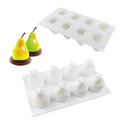 Set of six silicone baking moulds shaped as pineapples, pine cones, and pears on a kitchen counter.