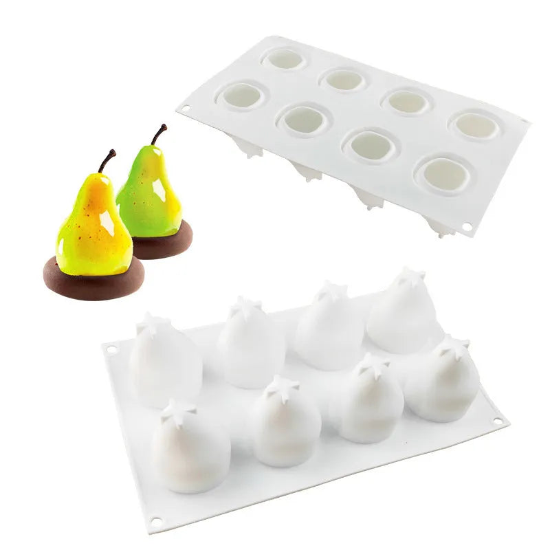 Set of six silicone baking moulds shaped as pineapples, pine cones, and pears on a kitchen counter.