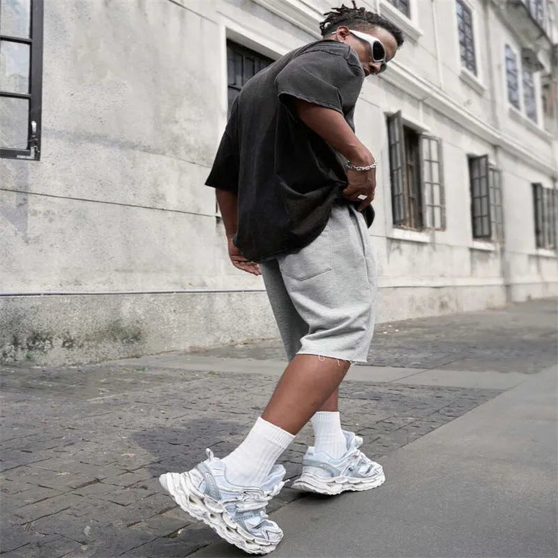 Men's black straight-leg hip-hop trousers in a medium length, laid flat.