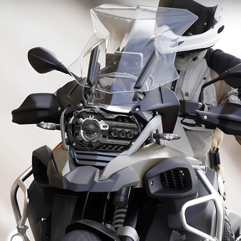 Black background LED motorcycle headlight unit showing front lens and housing.