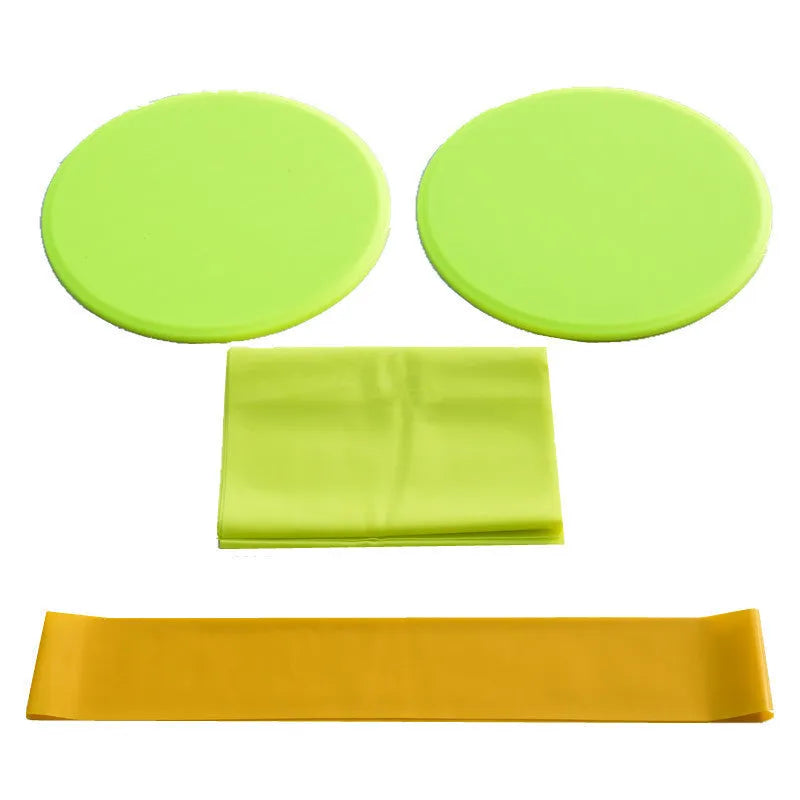 Colourful yoga fitness three-piece set with sliding discs, tension band, and resistance ring on a smooth floor