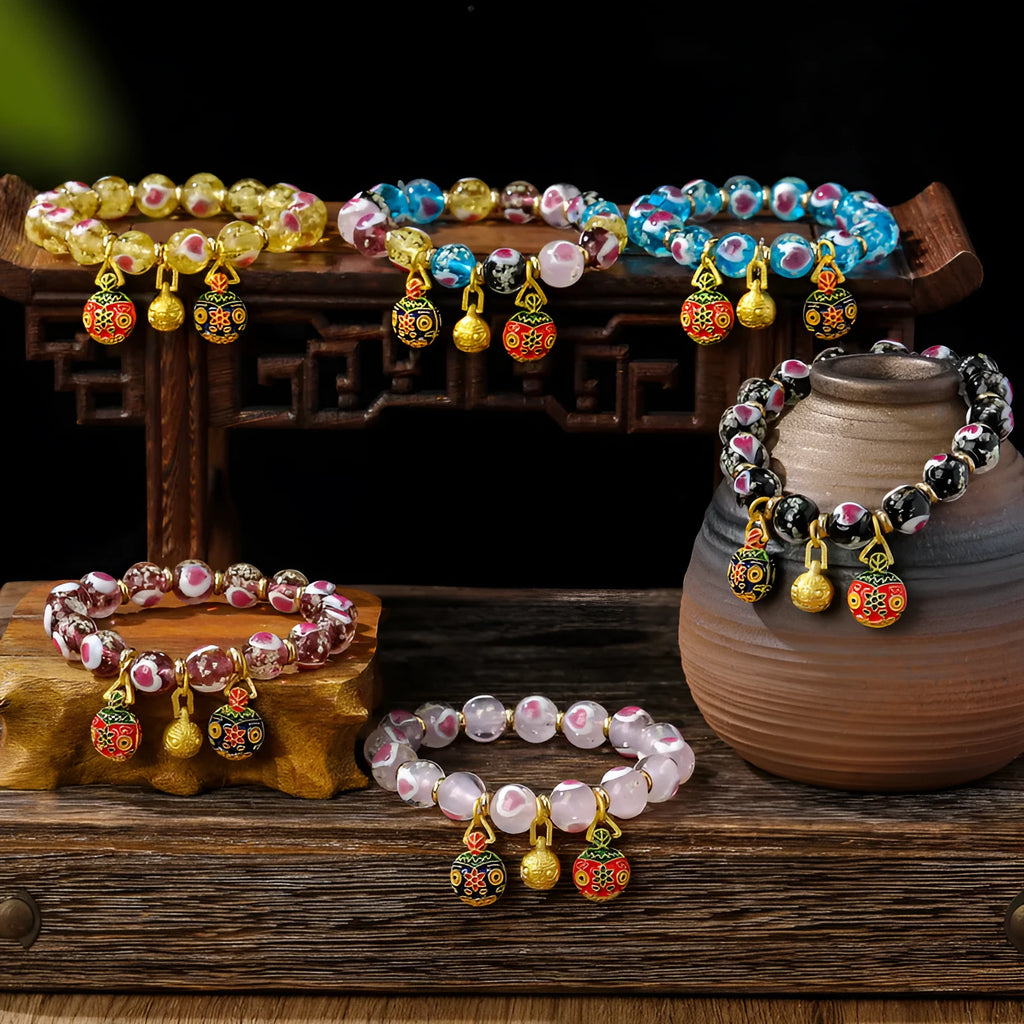 Handmade glass bracelet with swallowing gold beast design on heart-shaped 10mm beads