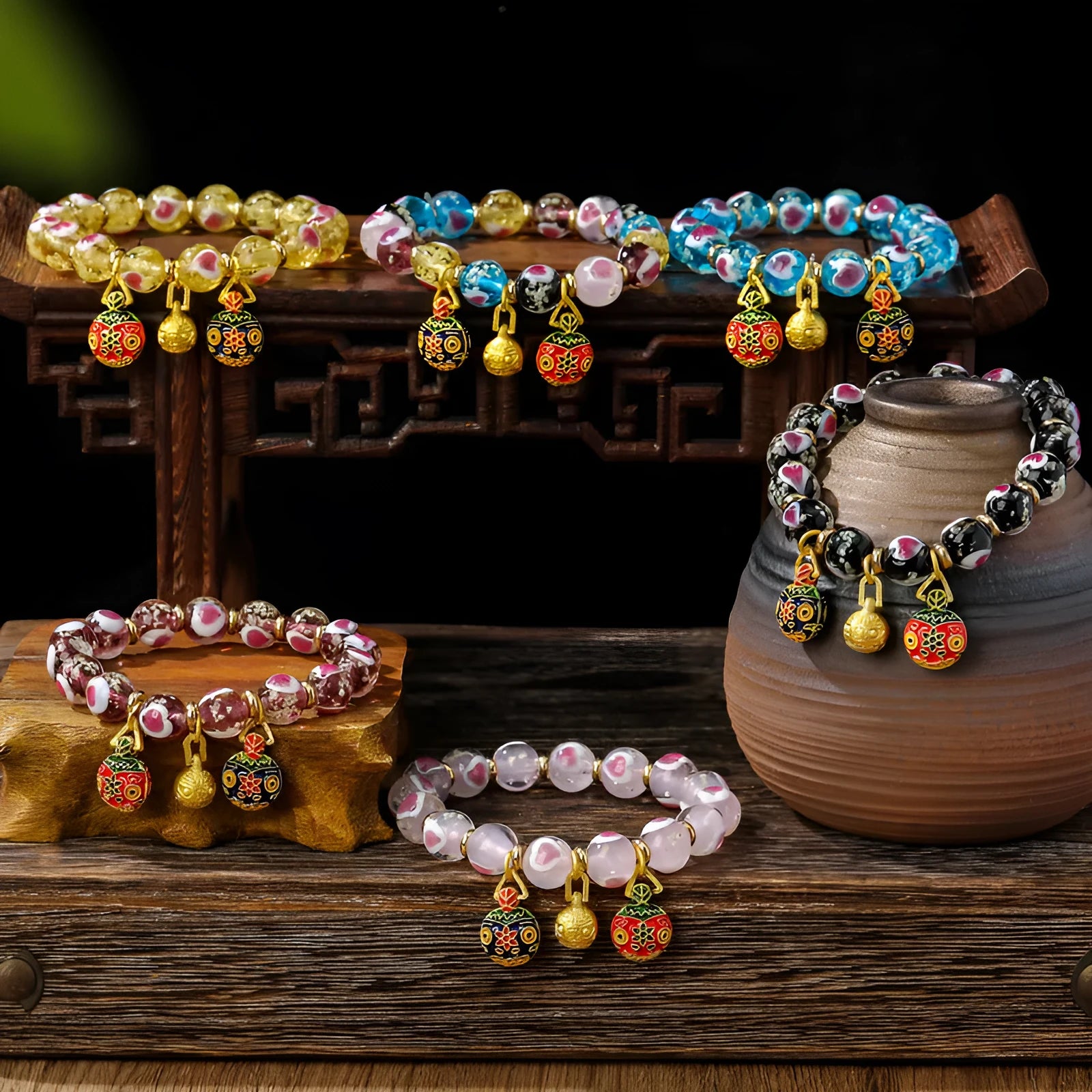 Handmade glass bracelet with swallowing gold beast design on heart-shaped 10mm beads