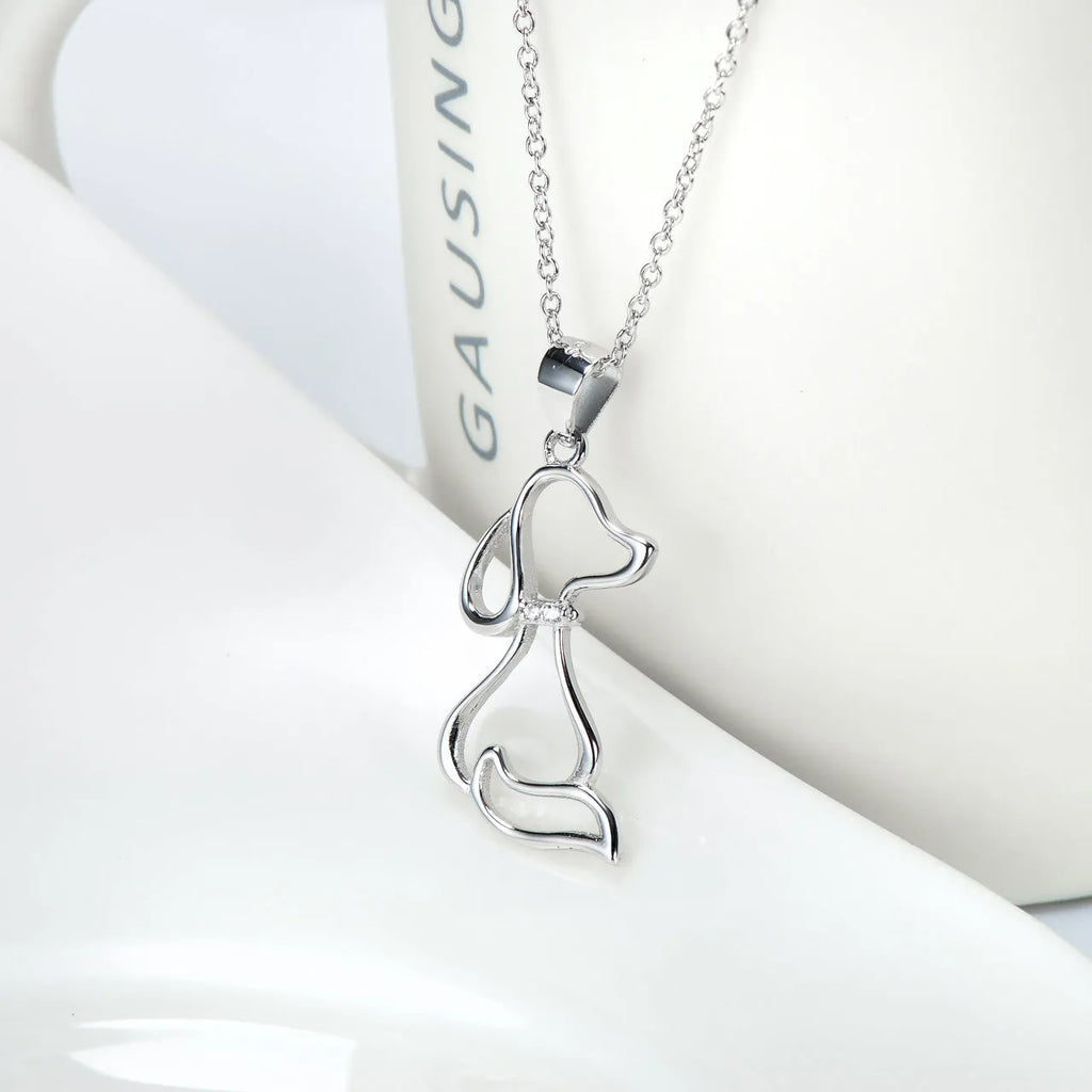 Ladies 925 sterling silver dog pendant necklace with adjustable round bead chain on neutral background